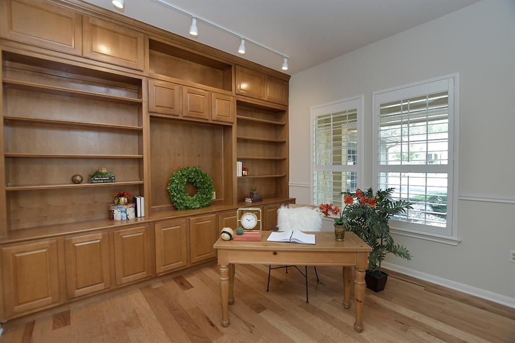 109 Sunflower Street Georgetown, TX 78633 - Photo 9 of 19 Home office with beautiful built-ins and hardwood flooring.