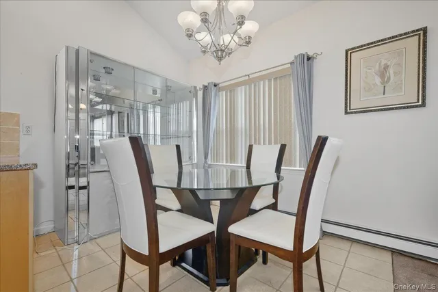 a view of a dining room with furniture and a chandelier