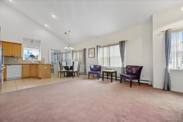 a living room with furniture and kitchen area