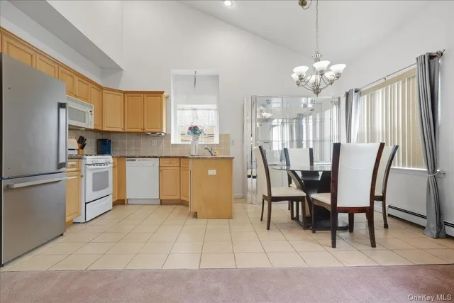 a view of kitchen with granite countertop cabinets table and chairs