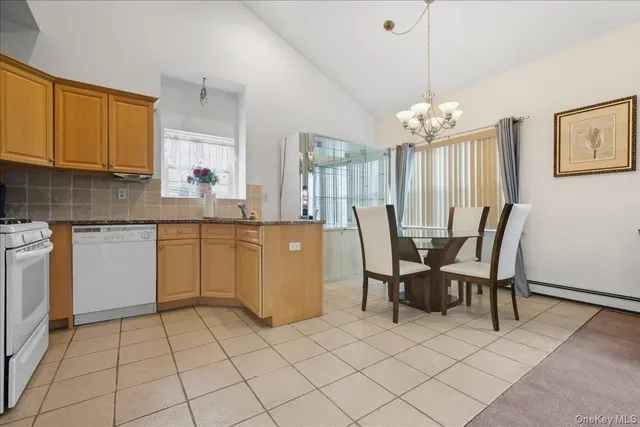 a view of kitchen with granite countertop cabinets table and chairs