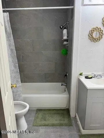 a bathroom with a toilet and a bathtub