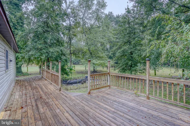 a view of a deck with trees in front of it