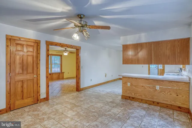 an empty room with a ceiling fan