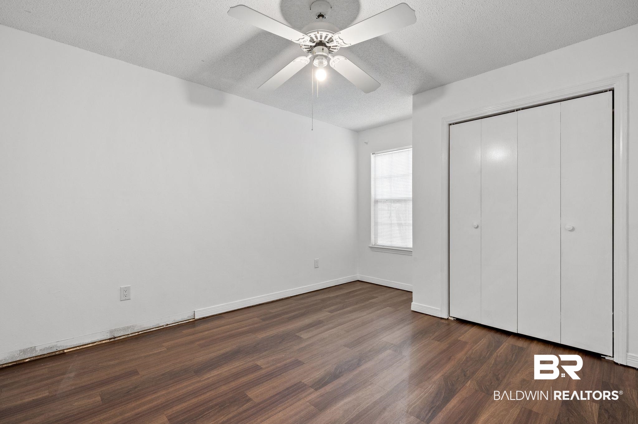 3716 Pepper Ridge Drive Mobile, AL 36693 - Photo 10 of 20 Unfurnished bedroom with a textured ceiling, ceiling fan, a closet, and dark hardwood / wood-style floors
