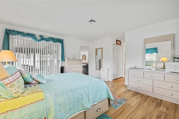 a bedroom with a bed and a dresser