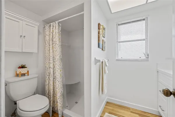 a bathroom with a toilet and a shower