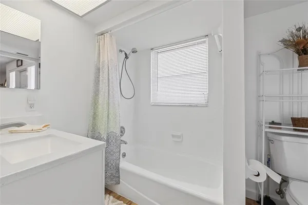 a bathroom with a sink a vanity and a shower