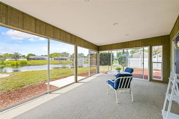 a living room with furniture and floor to ceiling windows