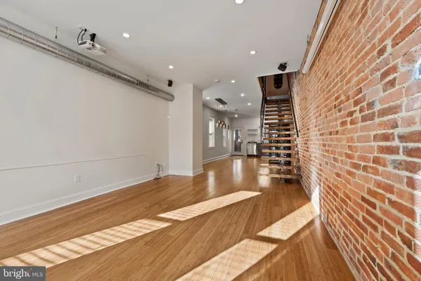 a view of a living room with a wooden floor