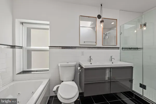 a bathroom with a toilet a sink and a bathtub