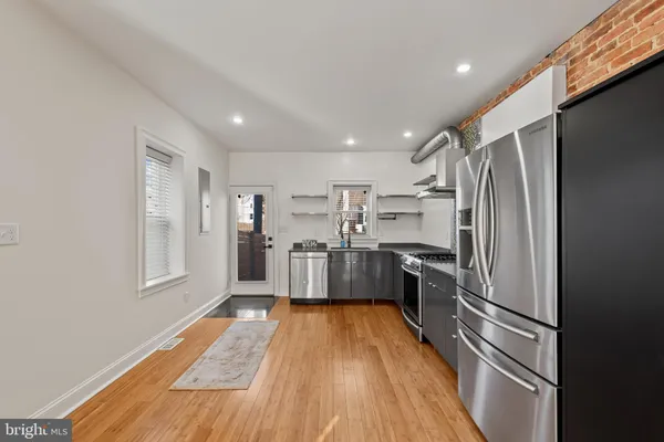 a kitchen with stainless steel appliances a refrigerator and a stove top oven