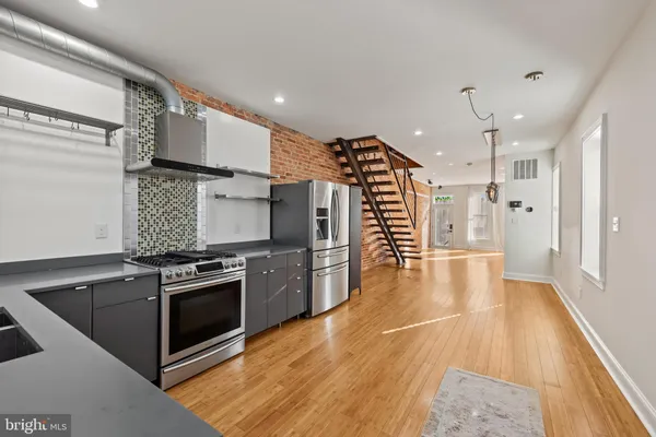 a kitchen with granite countertop a stove and a refrigerator