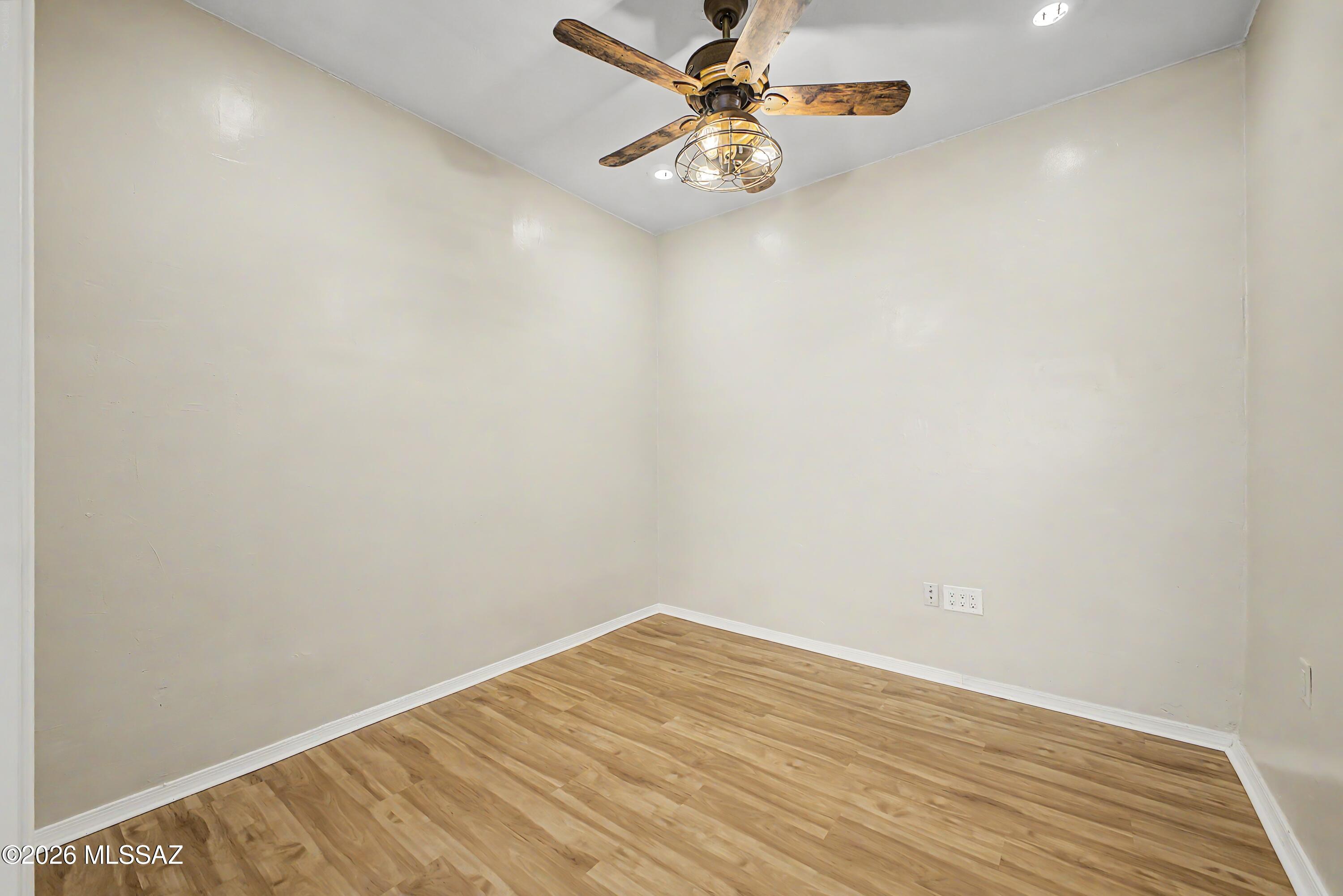 3781 East Edison Street Tucson, AZ 85716 - Photo 12 of 28 a view of a room with wooden floor and ceiling fan