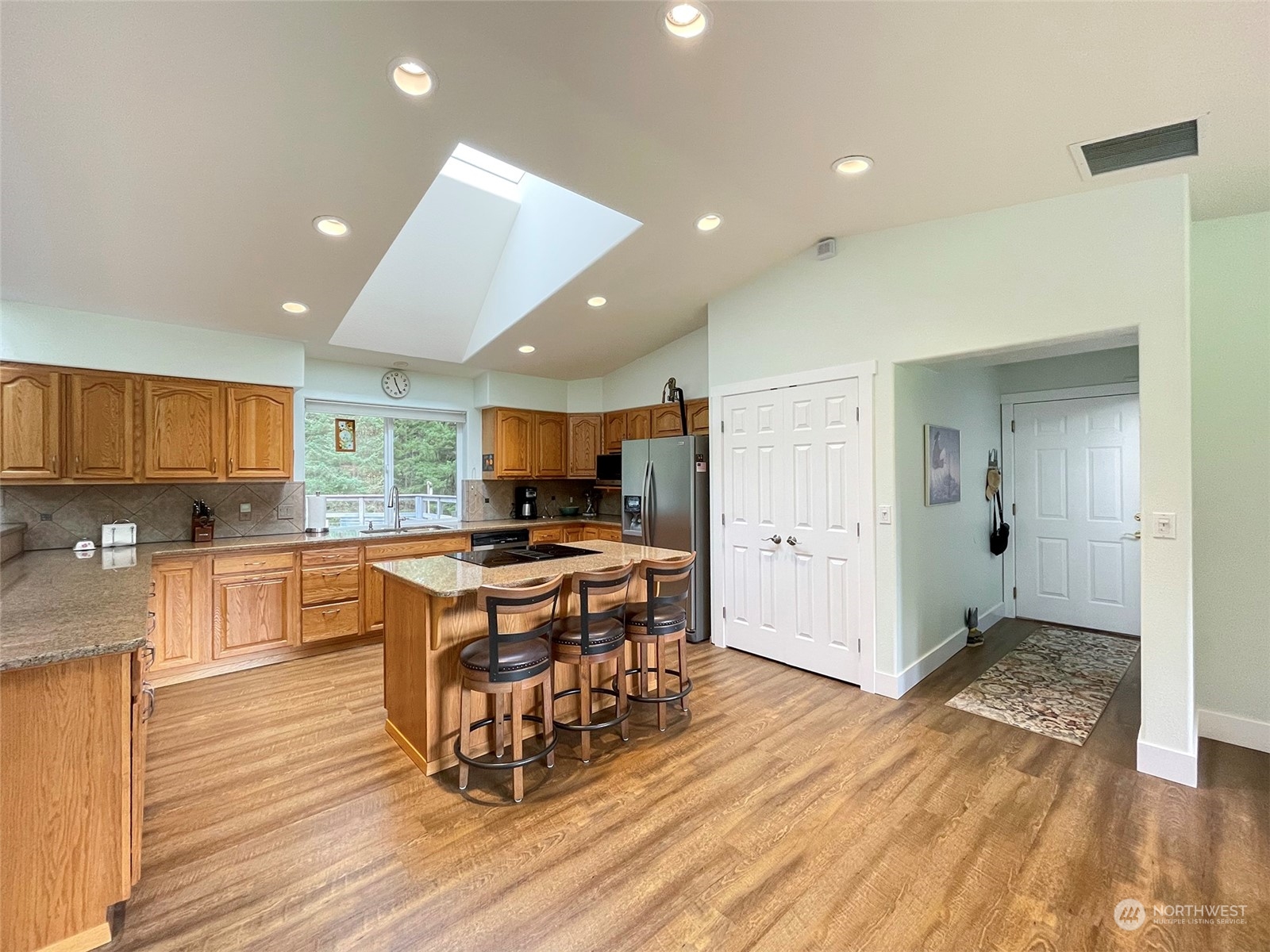 61 Sunny Dell Lane Sequim, WA 98382 - Photo 12 of 40 a kitchen with stainless steel appliances granite countertop a refrigerator and a stove top oven
