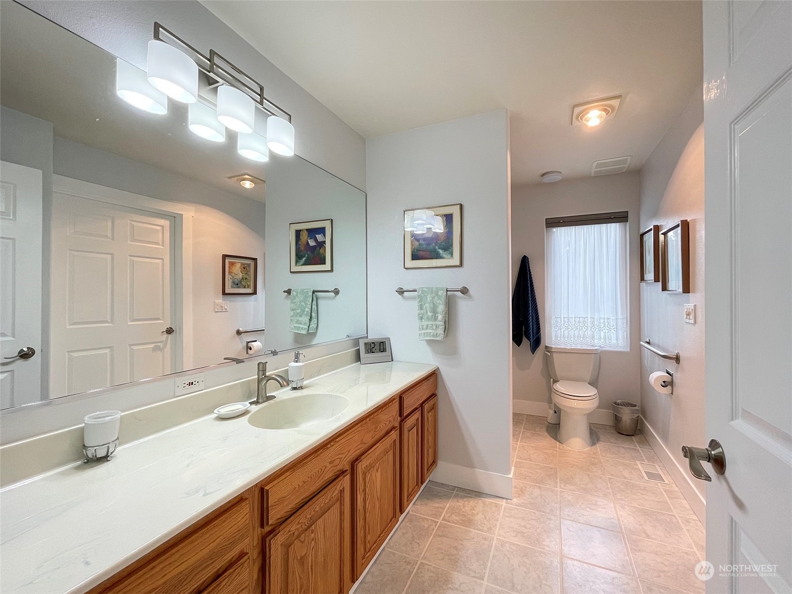 61 Sunny Dell Lane Sequim, WA 98382 - Photo 14 of 40 a spacious bathroom with a double vanity sink toilet and a mirror