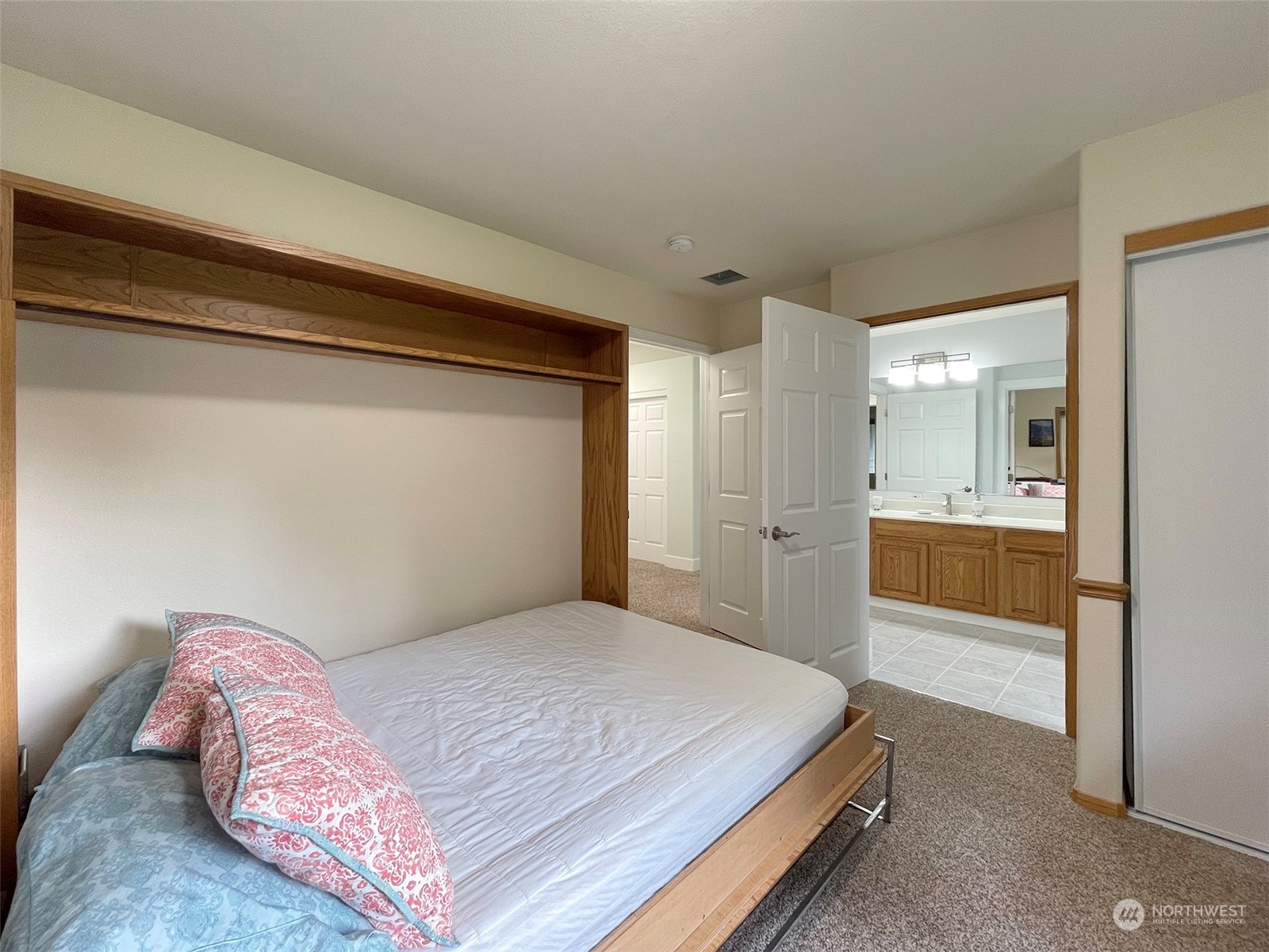61 Sunny Dell Lane Sequim, WA 98382 - Photo 17 of 40 a bedroom with a bed and a view of bathroom