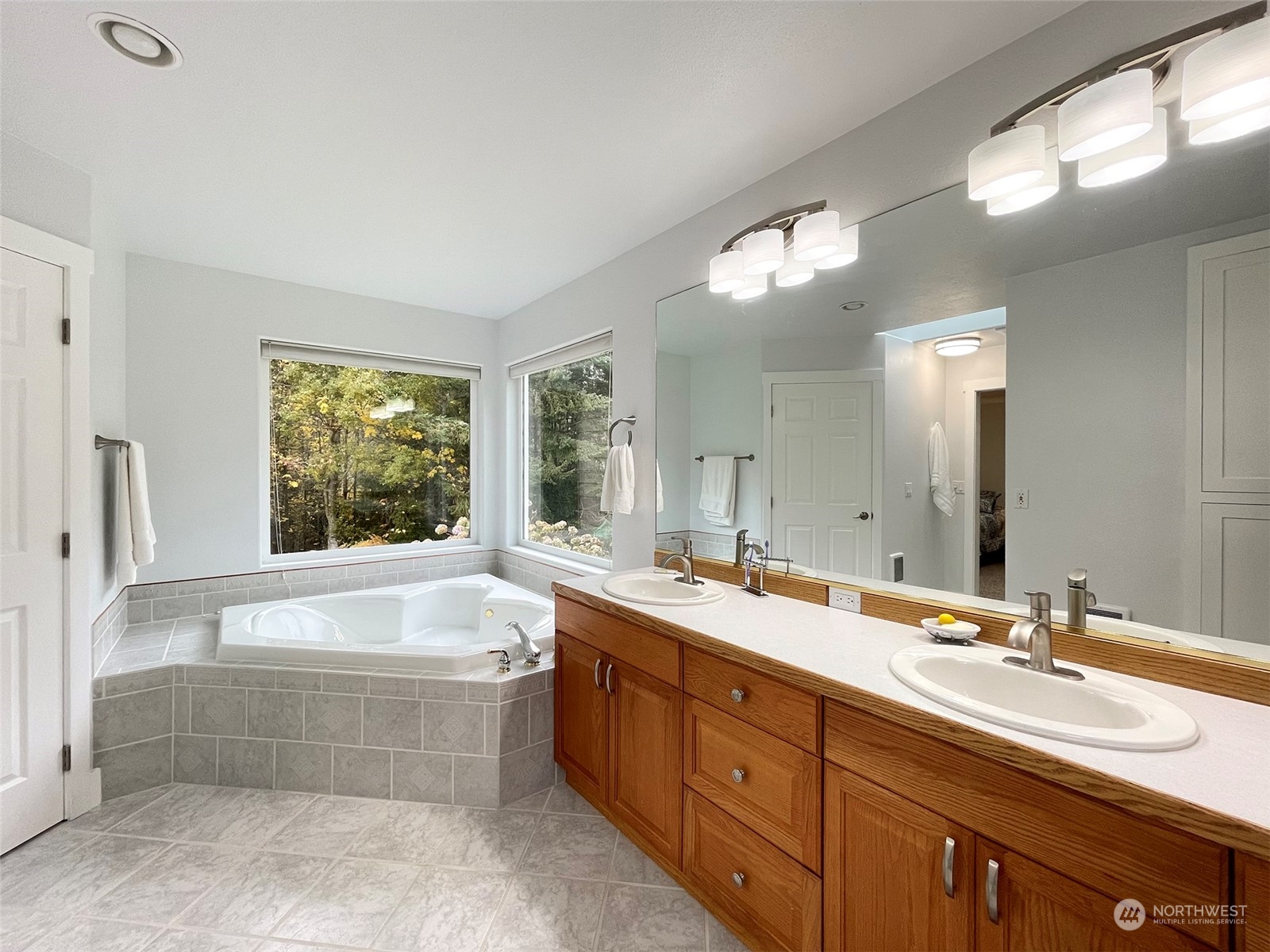 61 Sunny Dell Lane Sequim, WA 98382 - Photo 25 of 40 a bathroom with a large tub sink and double vanity