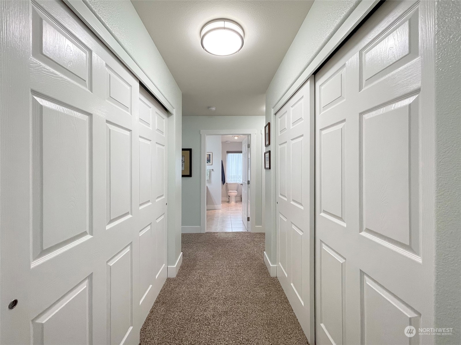 61 Sunny Dell Lane Sequim, WA 98382 - Photo 27 of 40 a view of a hallway with wooden floor and staircase
