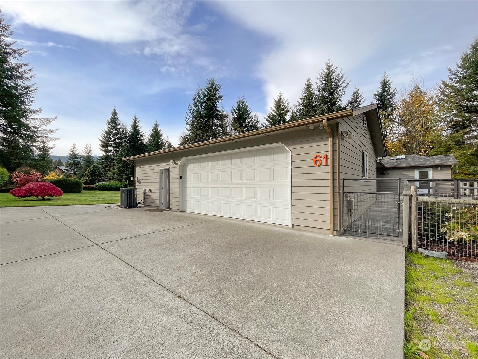 61 Sunny Dell Lane Sequim, WA 98382 - Photo 32 of 40 a view of a house with a yard and garage