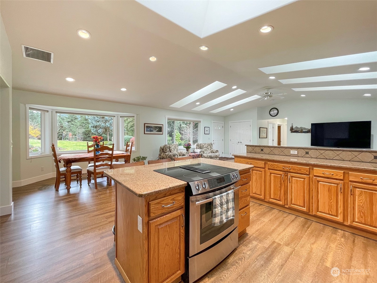 61 Sunny Dell Lane Sequim, WA 98382 - Photo 10 of 40 a kitchen with stainless steel appliances granite countertop stove top oven and cabinets