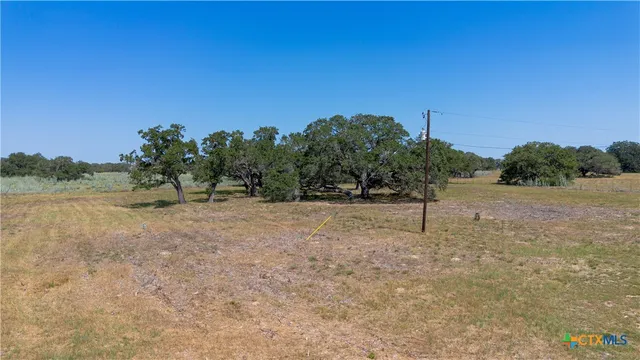 a view of a house with yard and lake view