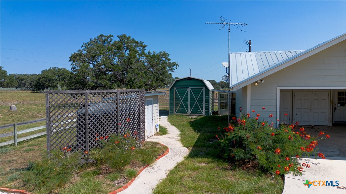 3752 Farm To Market 77 Nixon, TX 78140 - Photo 19 of 48 a front view of a house with a garden