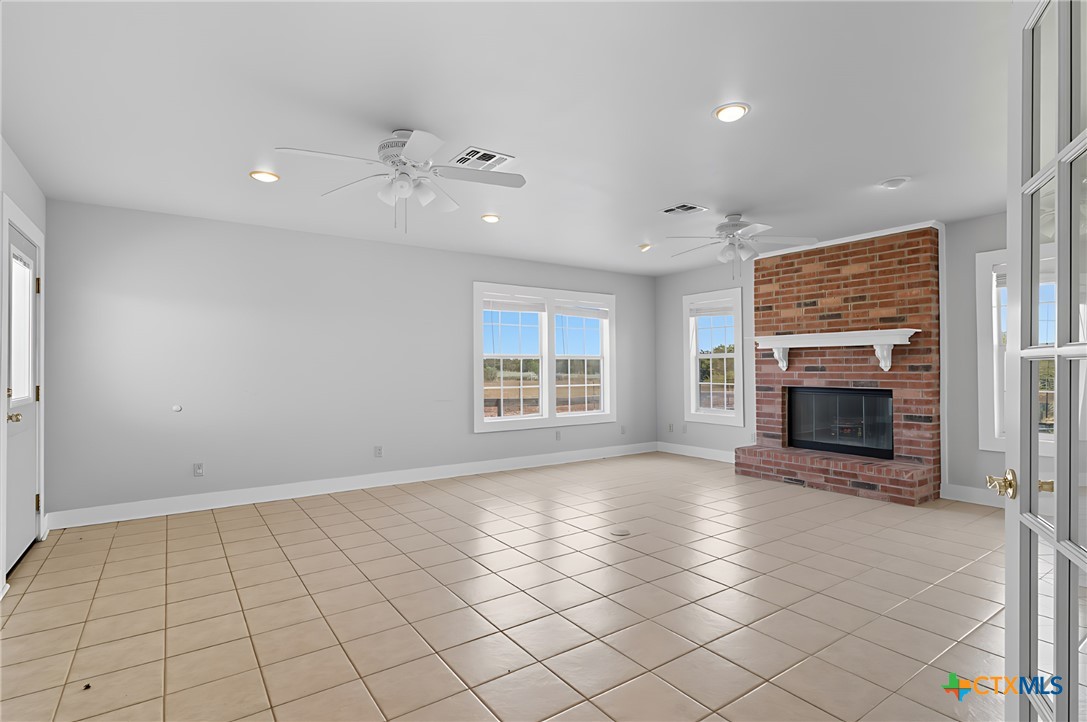 3752 Farm To Market 77 Nixon, TX 78140 - Photo 31 of 48 an empty room with windows and fireplace