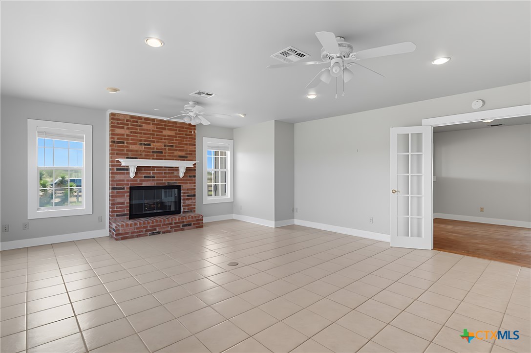 3752 Farm To Market 77 Nixon, TX 78140 - Photo 32 of 48 an empty room with windows and fireplace