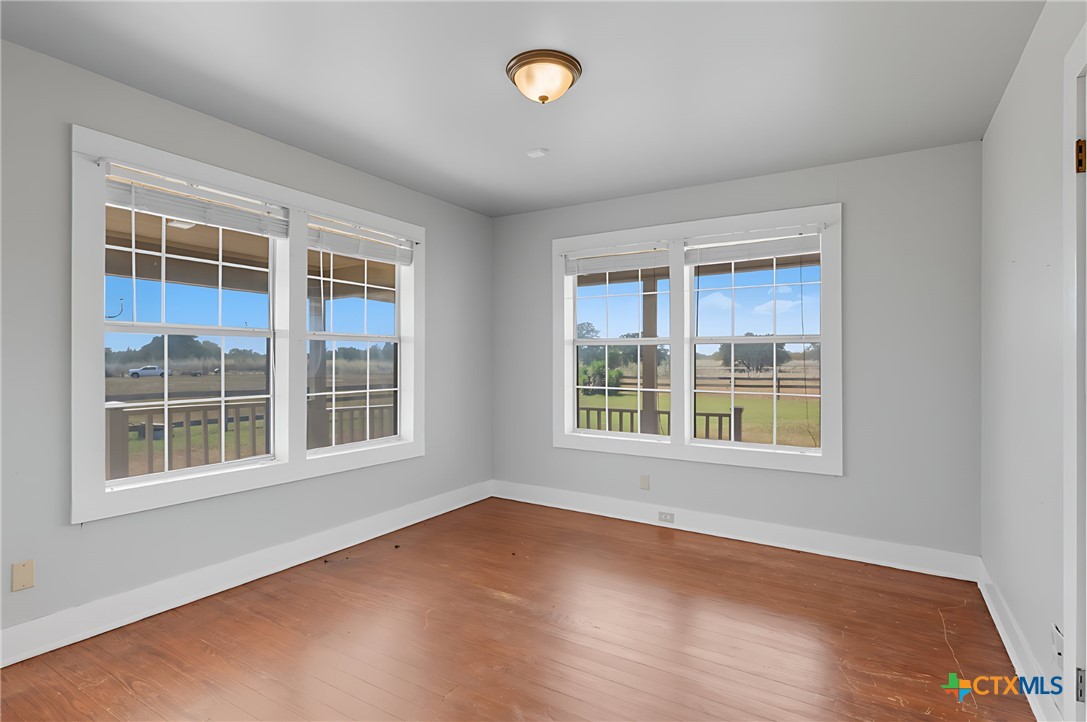 3752 Farm To Market 77 Nixon, TX 78140 - Photo 34 of 48 an empty room with wooden floor and windows