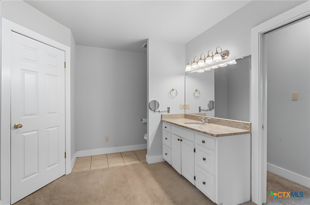 3752 Farm To Market 77 Nixon, TX 78140 - Photo 42 of 48 a spacious bathroom with a granite countertop sink a mirror and a