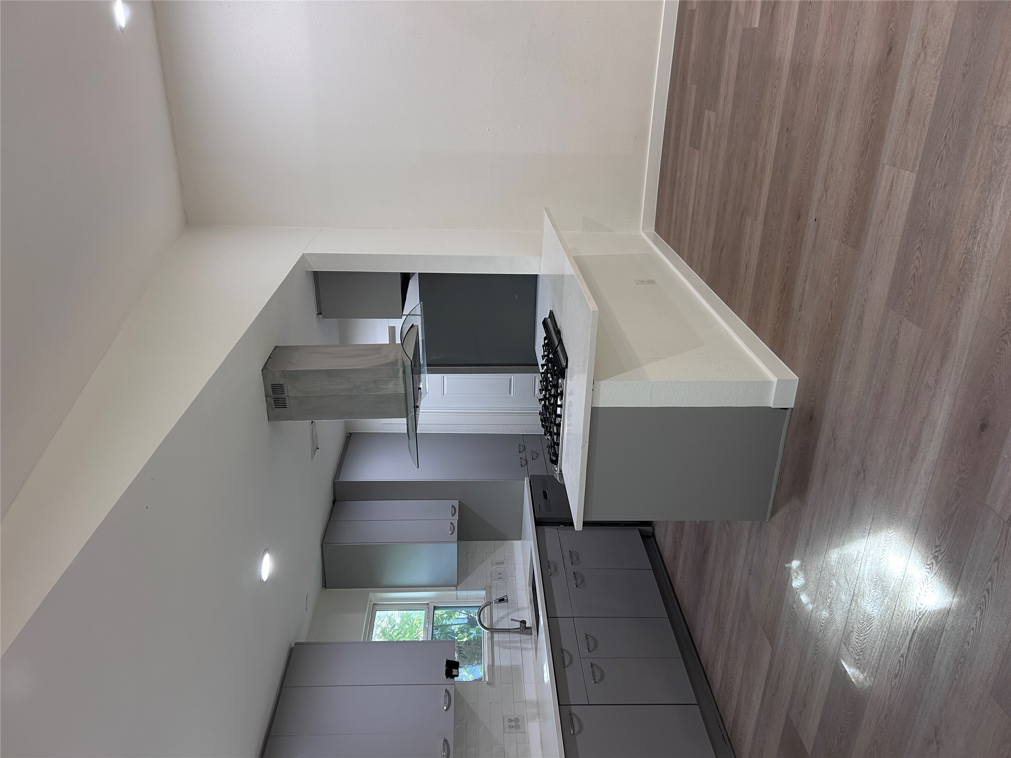6603 Ripple Run Austin, TX 78744 - Photo 4 of 16 A well-appointed kitchen showcasing contemporary cabinetry and resilient wood-look flooring.