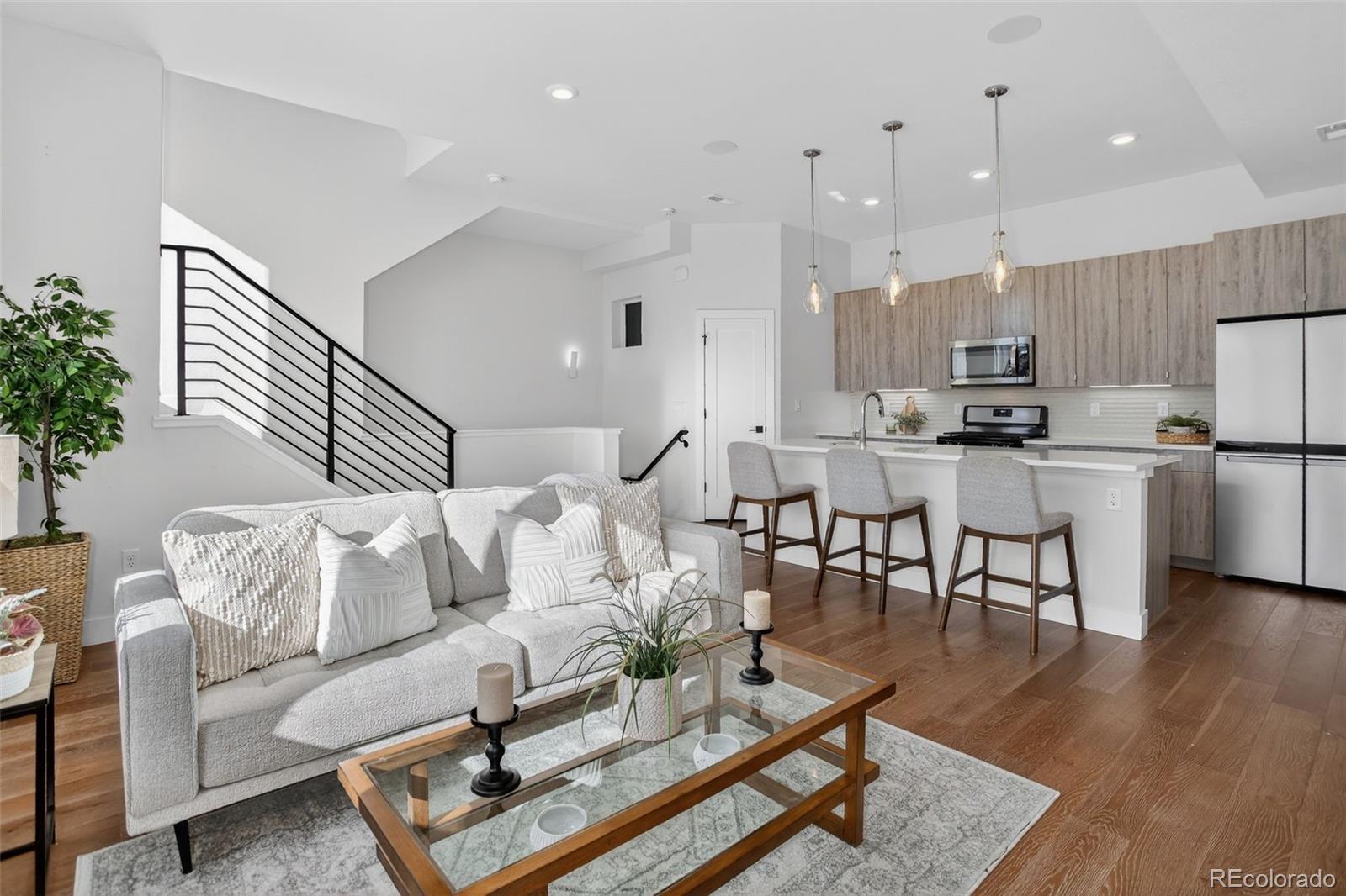 a living room with furniture and kitchen view