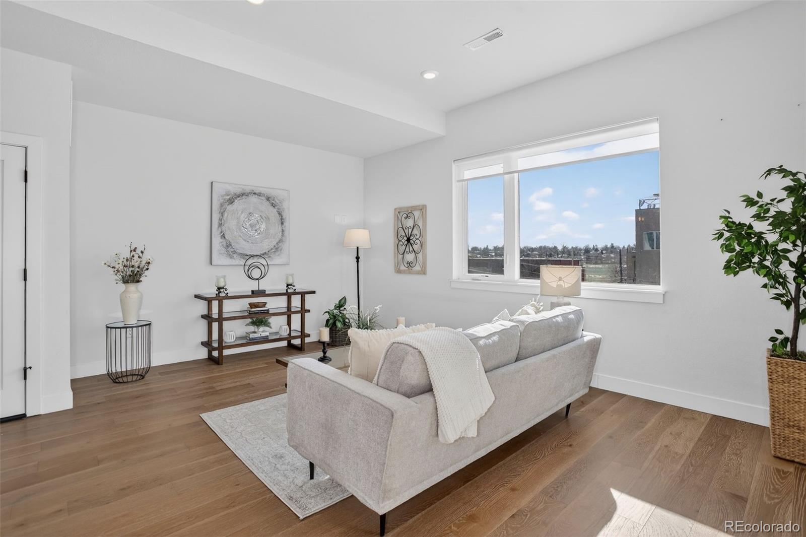 1234 Perry Street Denver, CO 80204 - Photo 13 of 29 a living room with furniture and a large window