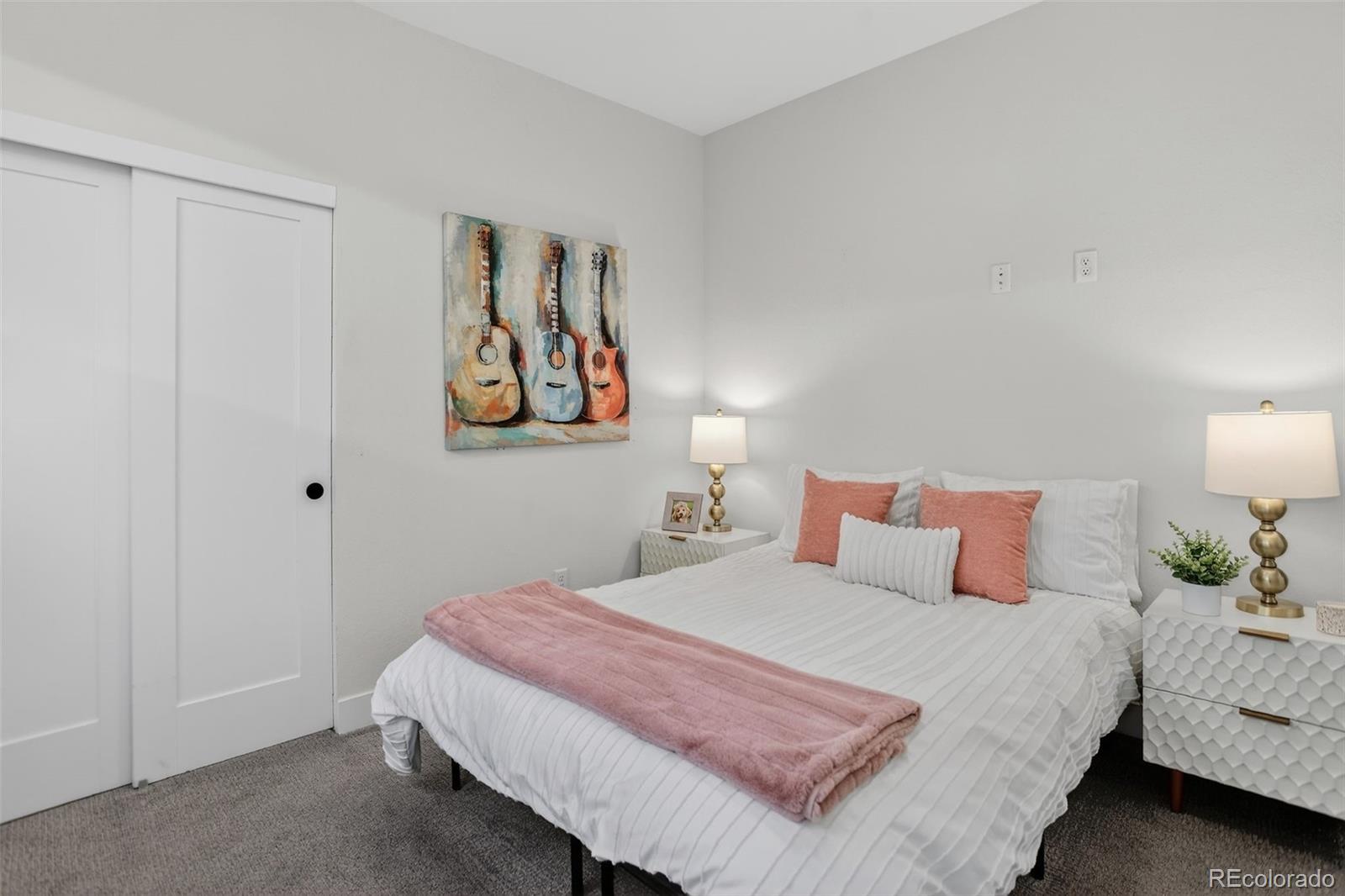 1234 Perry Street Denver, CO 80204 - Photo 18 of 29 a bedroom with a bed and lamp