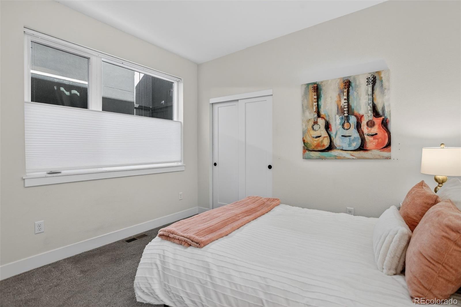 1234 Perry Street Denver, CO 80204 - Photo 19 of 29 a bedroom with a bed and a refrigerator
