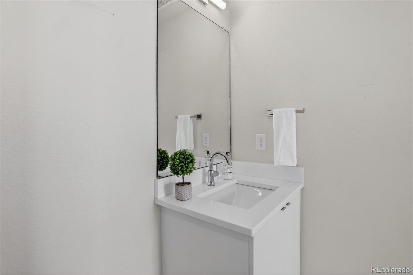 1234 Perry Street Denver, CO 80204 - Photo 22 of 29 a bathroom with a sink and a mirror