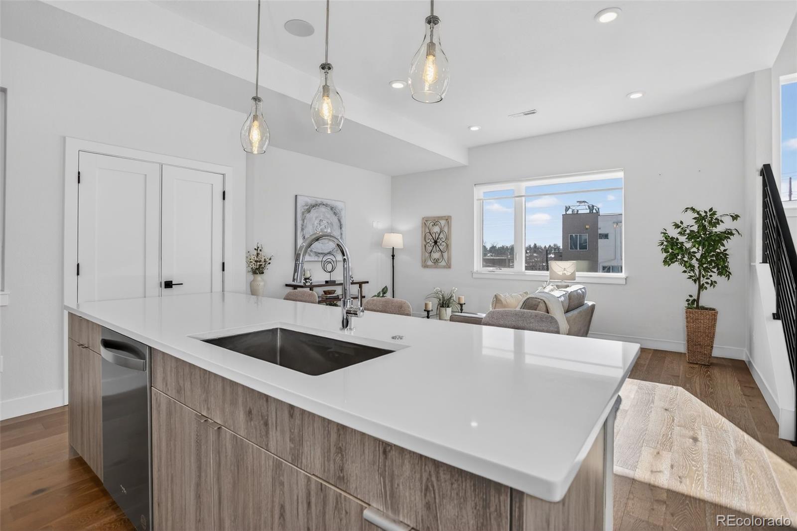 1234 Perry Street Denver, CO 80204 - Photo 9 of 29 a large kitchen with kitchen island a sink stainless steel appliances and cabinets