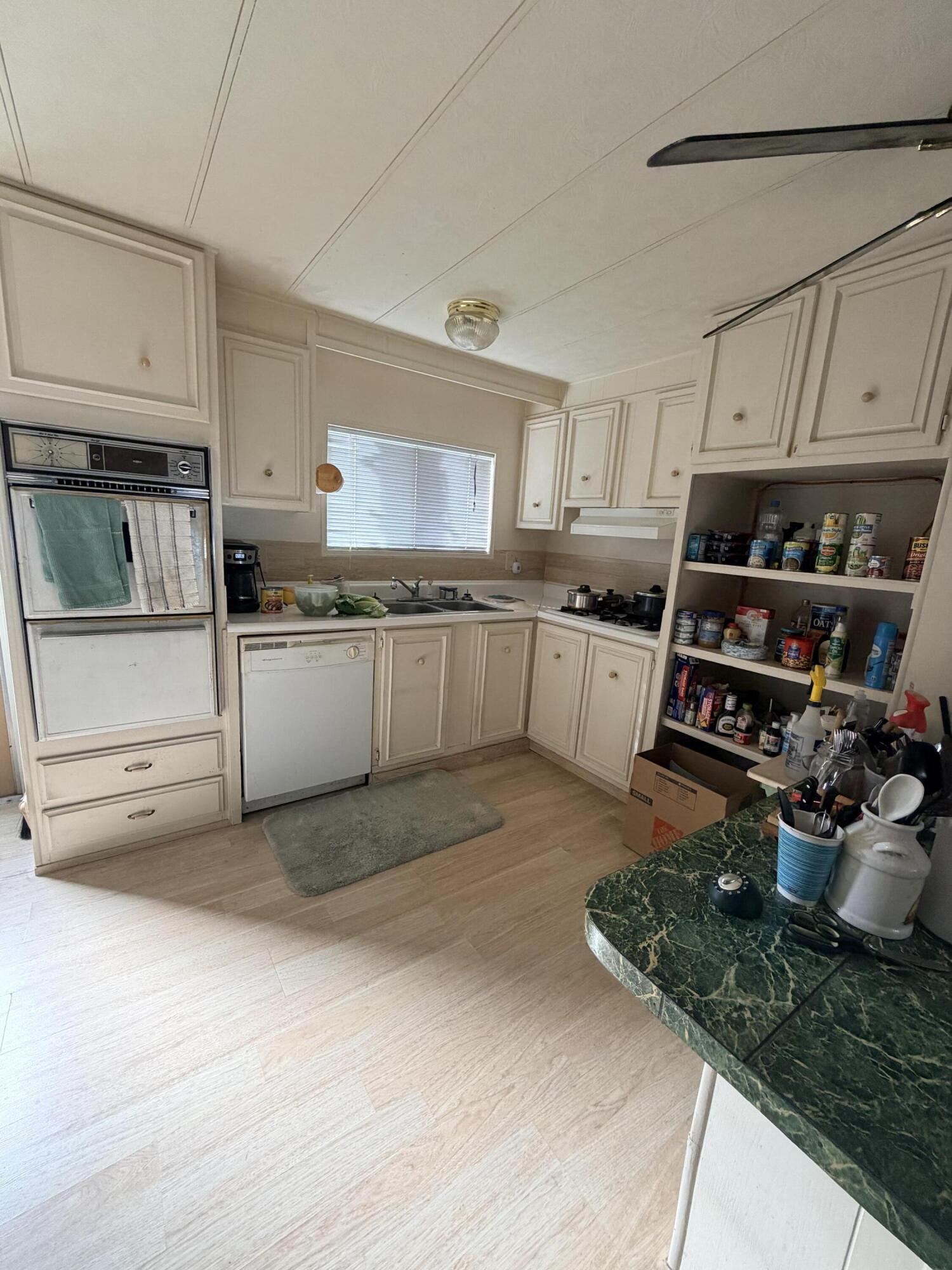 288 Turf Paradise Street Rancho Mirage, CA 92270 - Photo 13 of 18 a kitchen with stainless steel appliances granite countertop a sink stove and cabinets