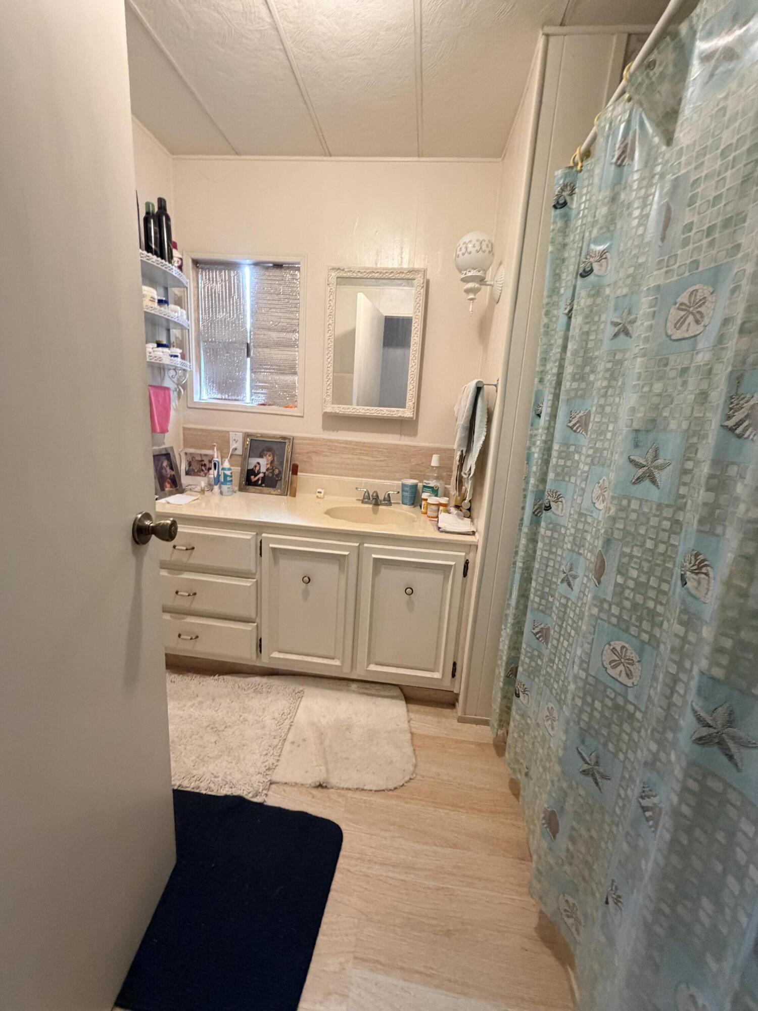 288 Turf Paradise Street Rancho Mirage, CA 92270 - Photo 17 of 18 a bathroom with a sink a vanity and a mirror