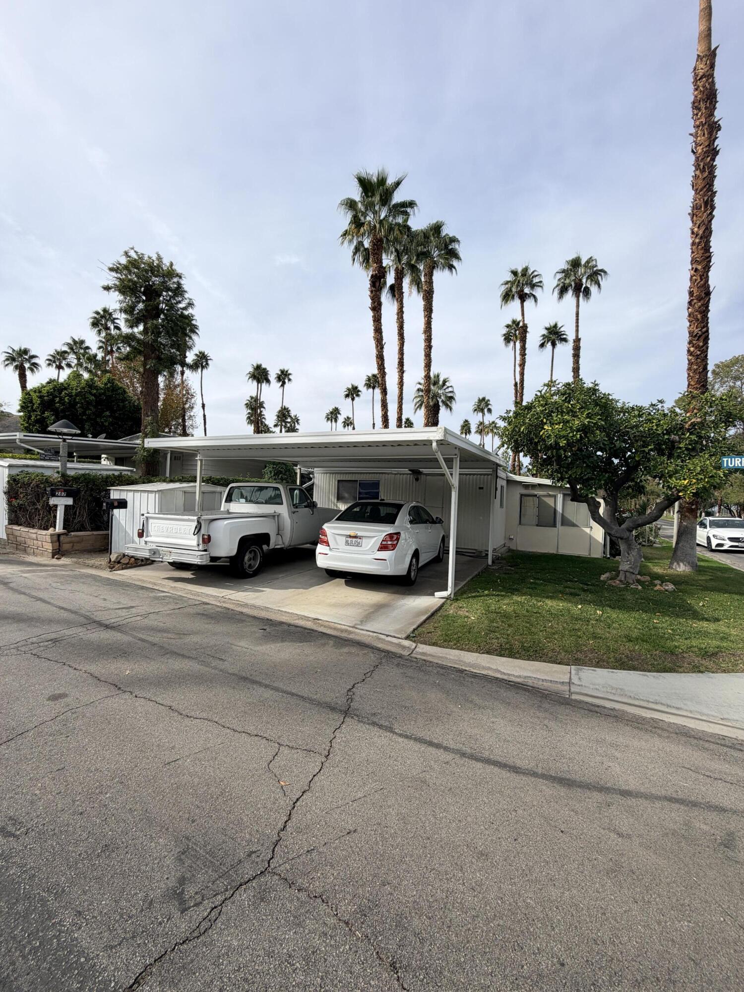 288 Turf Paradise Street Rancho Mirage, CA 92270 - Photo 4 of 18 a car parked on the side of the road