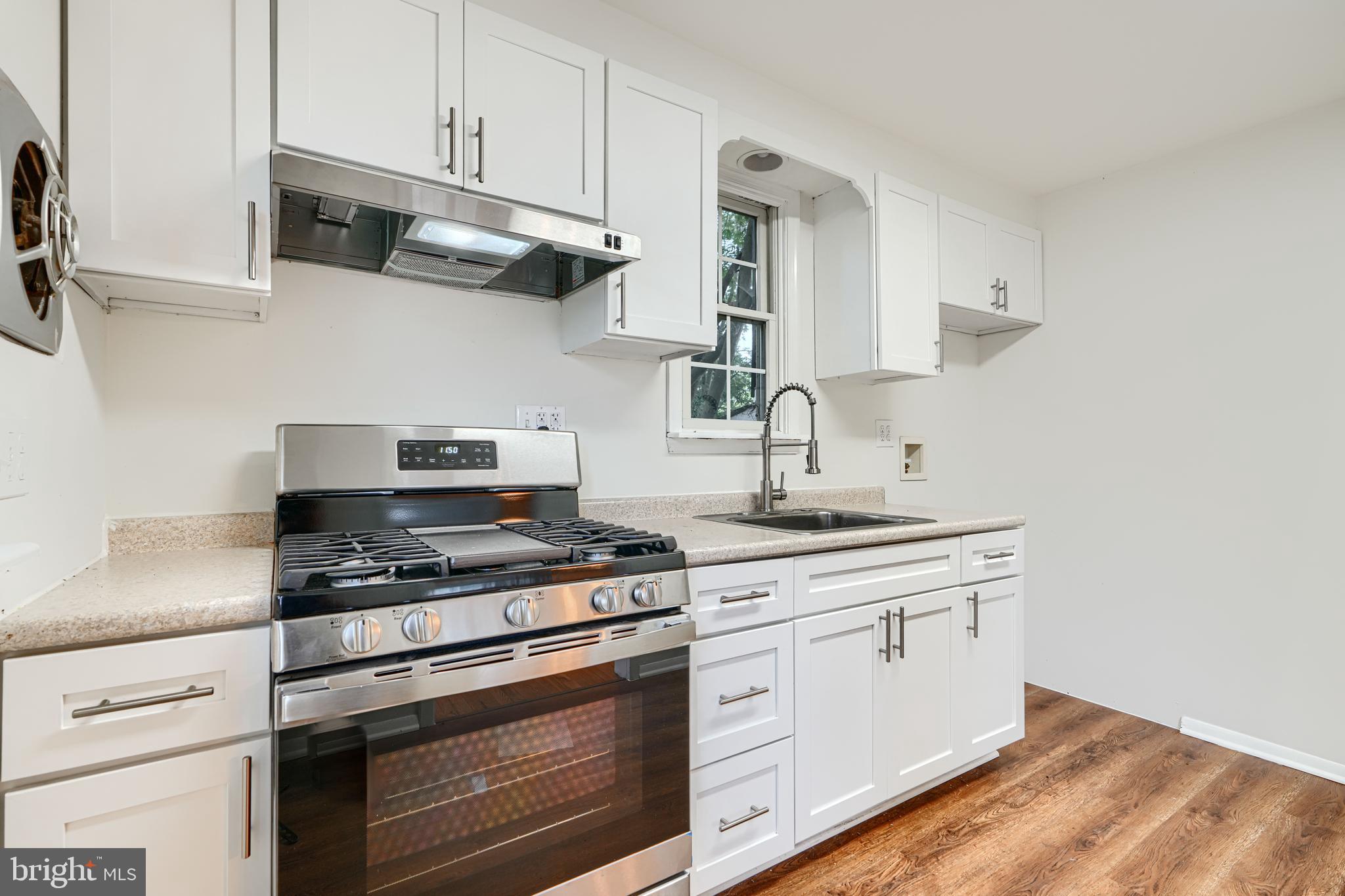 1813 Weyburn Road Baltimore, MD 21237 - Photo 11 of 39 a kitchen with stainless steel appliances granite countertop white cabinets a stove a sink and dishwasher