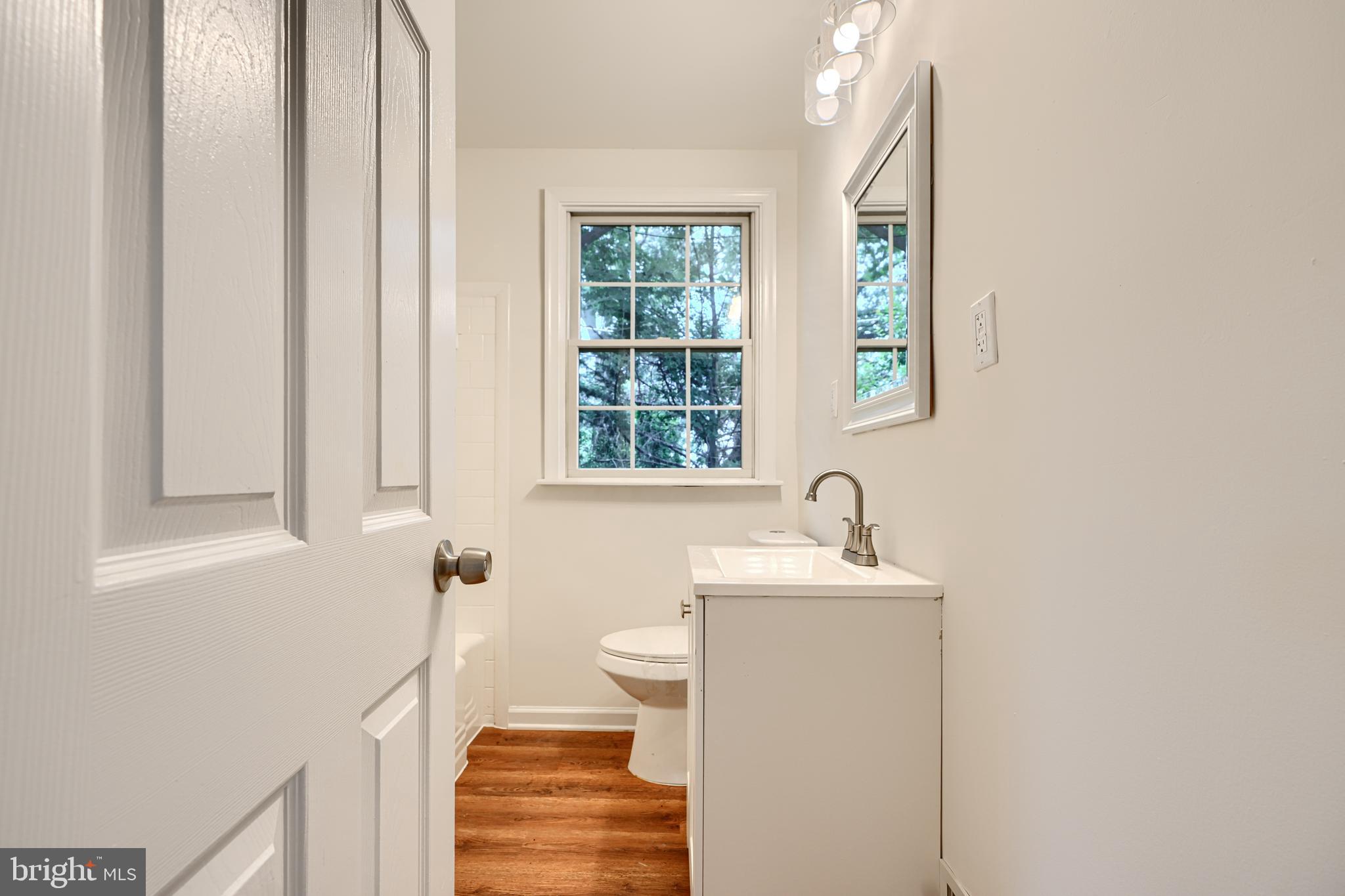 1813 Weyburn Road Baltimore, MD 21237 - Photo 21 of 39 a bathroom with a sink a window and a mirror