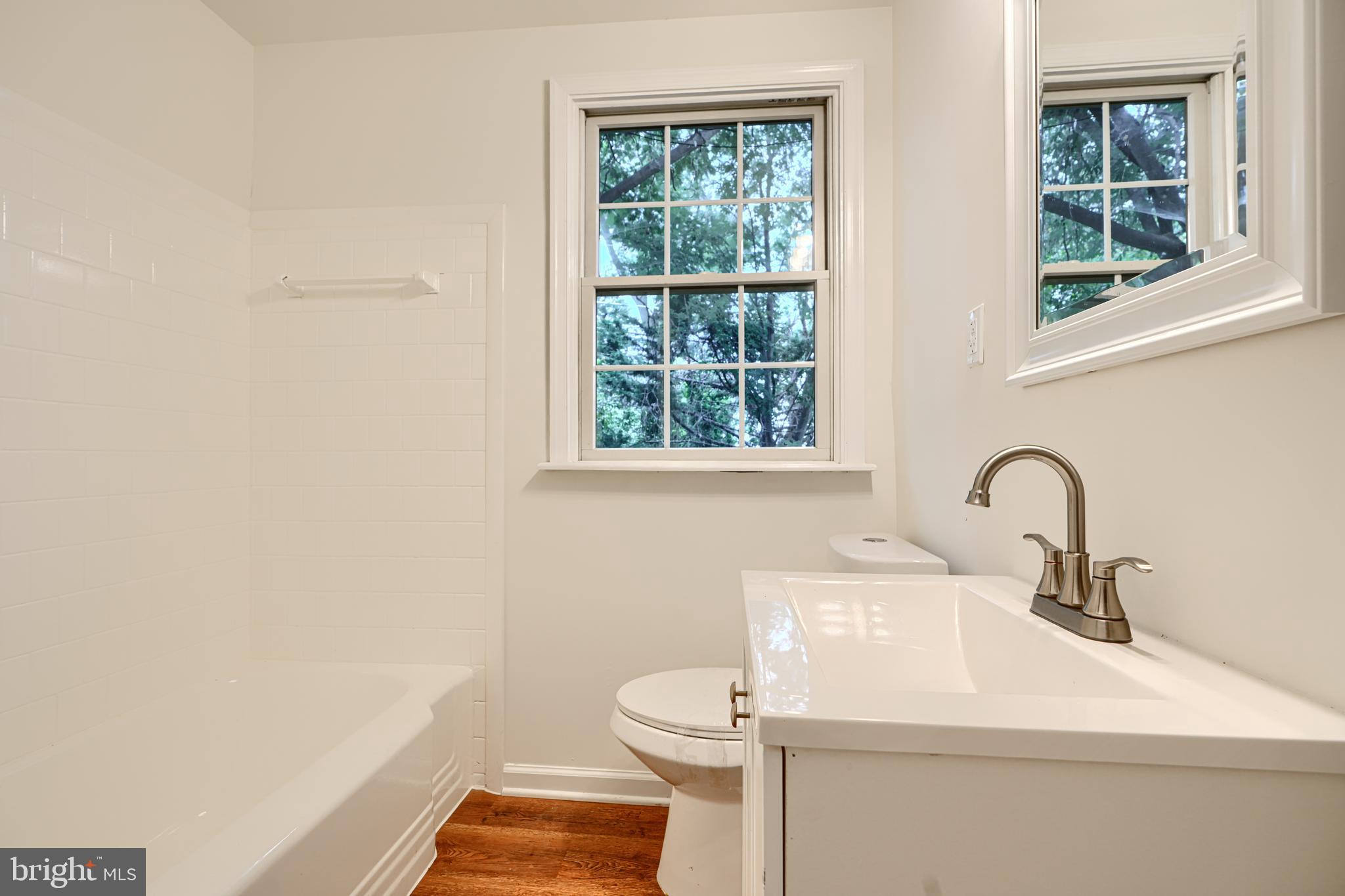 1813 Weyburn Road Baltimore, MD 21237 - Photo 22 of 39 a bathroom with a sink a toilet and a window