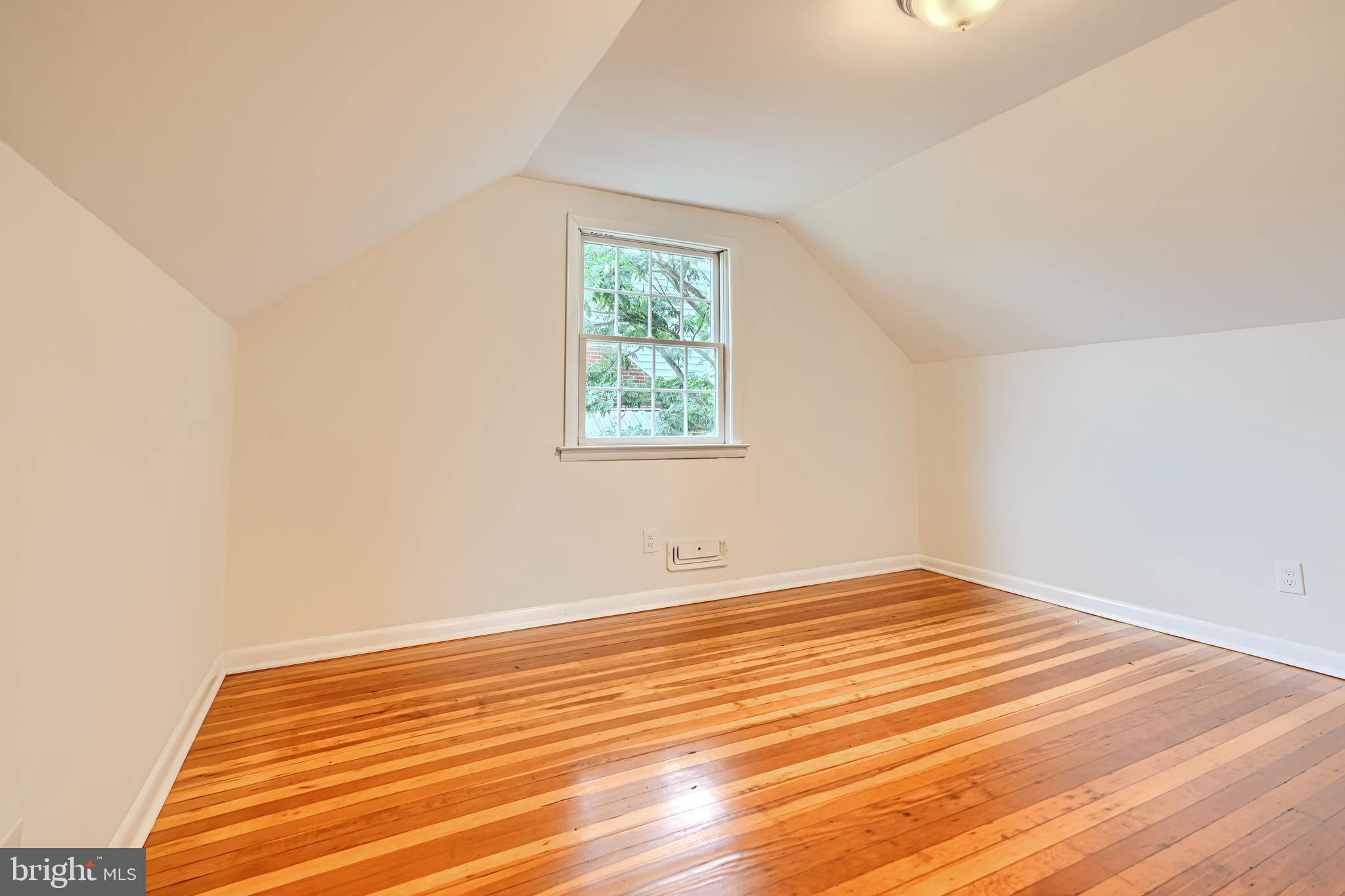 1813 Weyburn Road Baltimore, MD 21237 - Photo 24 of 39 an empty room with wooden floor and windows