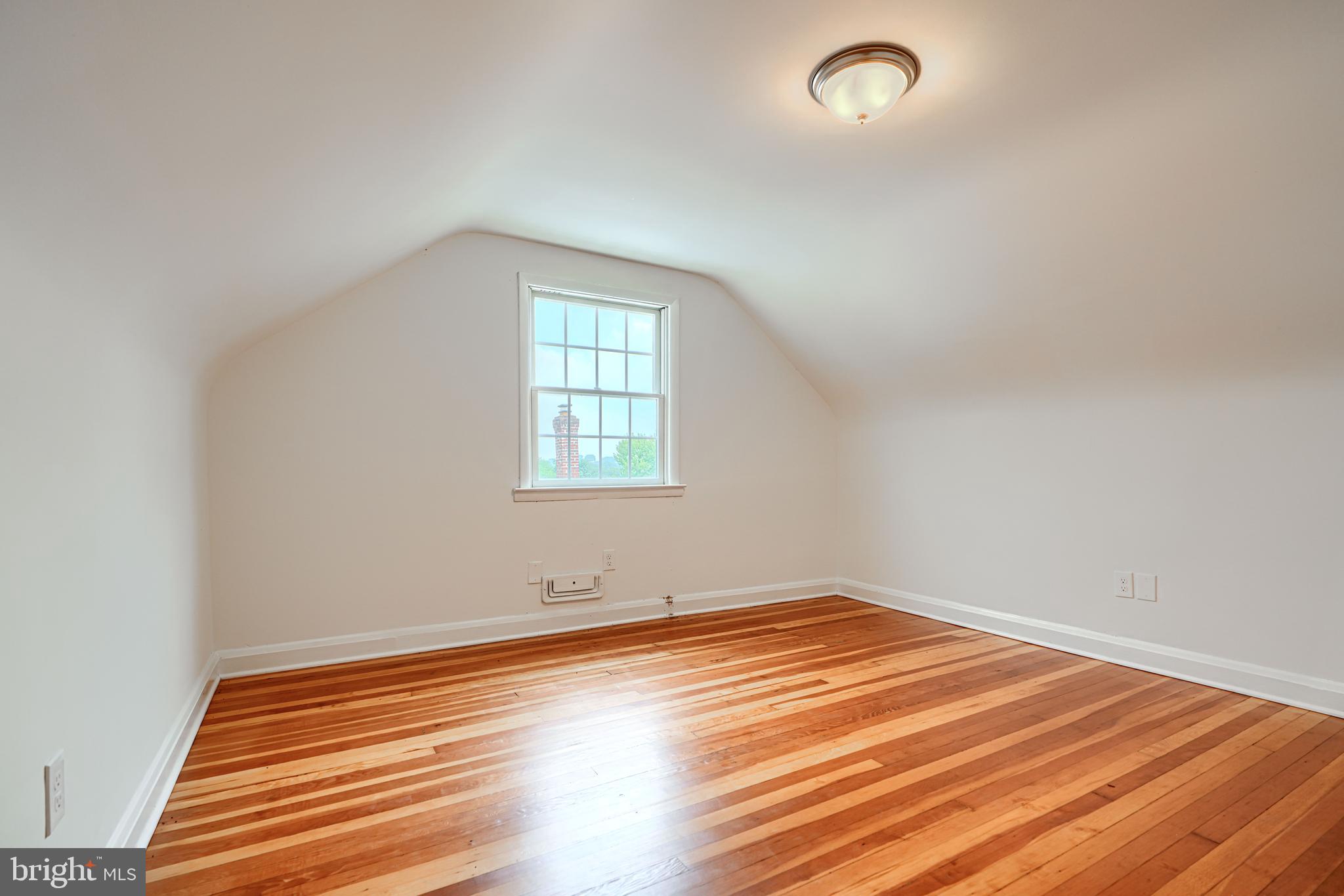 1813 Weyburn Road Baltimore, MD 21237 - Photo 27 of 39 an empty room with wooden floor and windows
