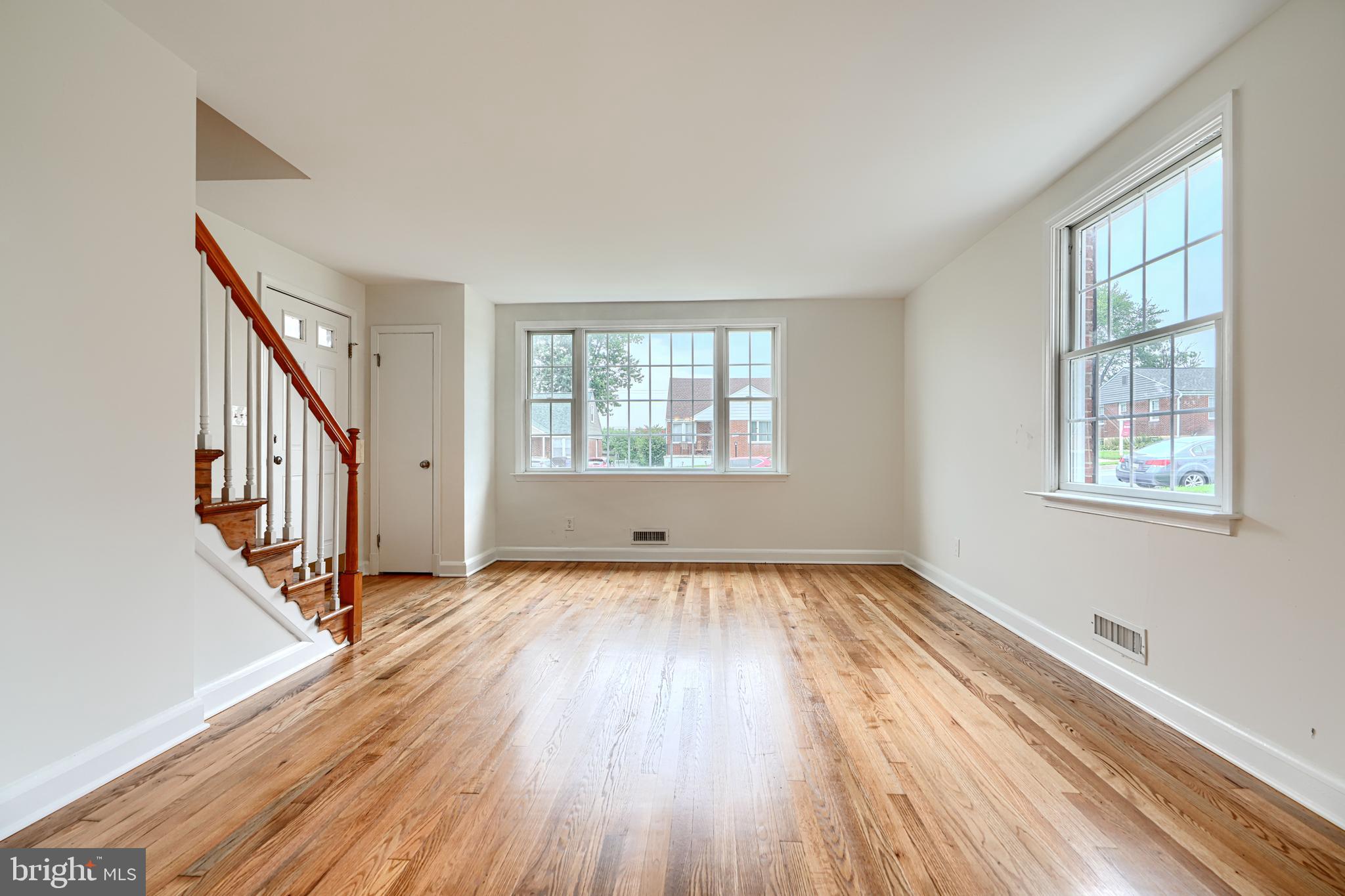 1813 Weyburn Road Baltimore, MD 21237 - Photo 5 of 39 a view of an empty room with wooden floor and a window