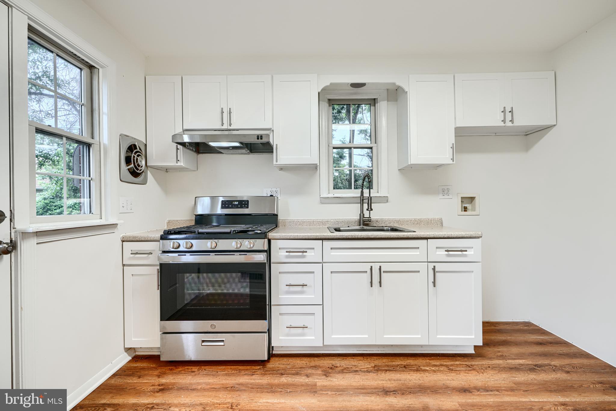 1813 Weyburn Road Baltimore, MD 21237 - Photo 10 of 39 a kitchen with stainless steel appliances granite countertop a stove and white cabinets
