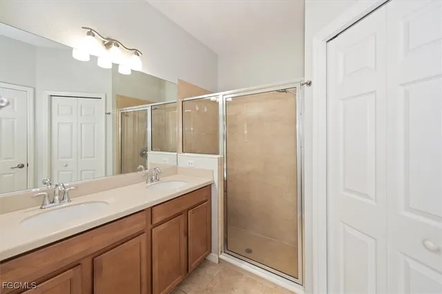 a bathroom with a double vanity sink and a mirror