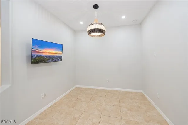 a view of a room with a hanging light and kitchen